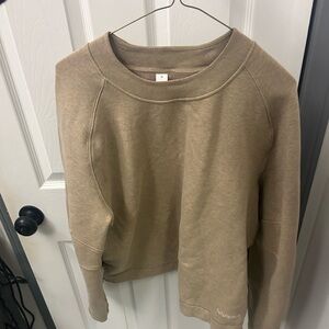 NWOT LULULEMON logo sweatshirt with zipper on the sides.